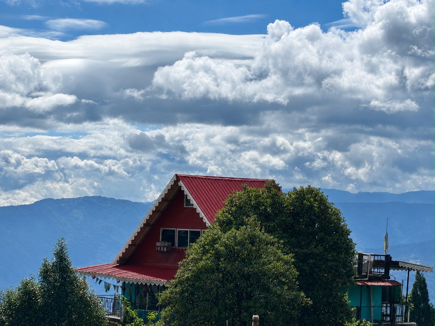 Red Gable Roof & Alpine Sky